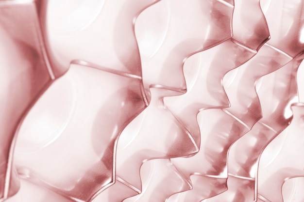 Pink background made of plastic packaging for candy Perforated packaging design Side view