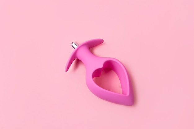 Photo on a pink background sex product, a toy for adults