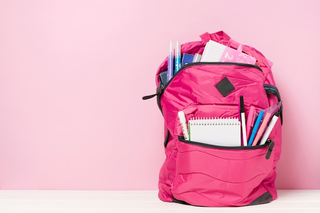 Pink backpack with school materials 