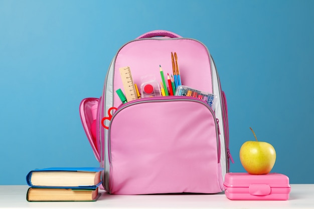 Pink backpack with stationery objects