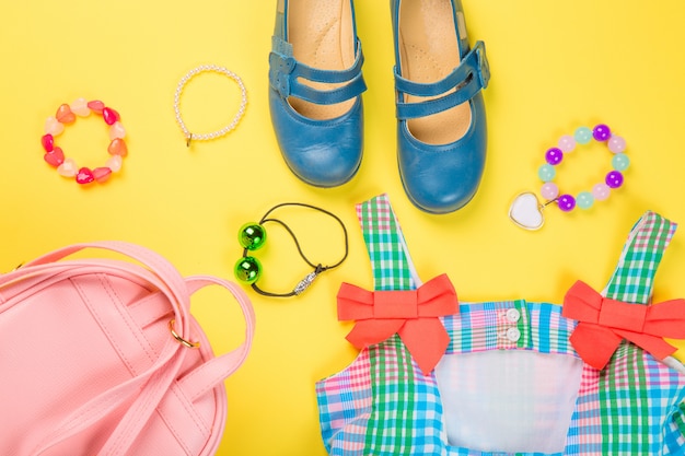 Pink bag with colorful dress, circlet, hair ties and shoes 