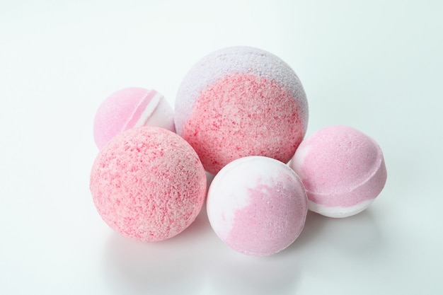 Pink bath balls on white background, close up