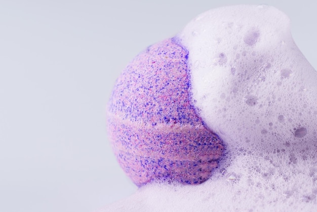Pink bath bomb with soap on white background closeup