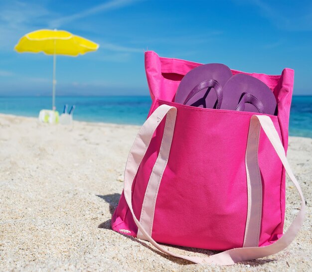 Pink beach bag on the sand