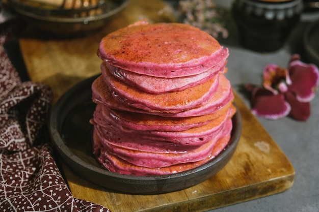 Pink beet pancakes poured honey