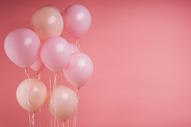 Pink birthday helium balloons on pink studio