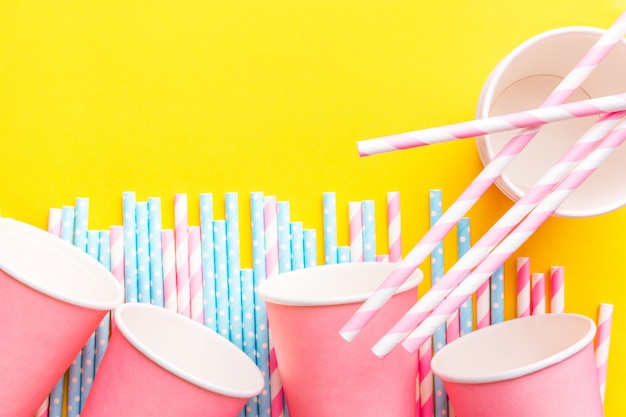 Pink and blue paper straws and pink cups