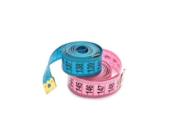 Pink and blue plastic measure tape with metric scale isolated on white background