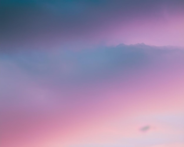 A pink and blue sky with a pink and blue cloud.