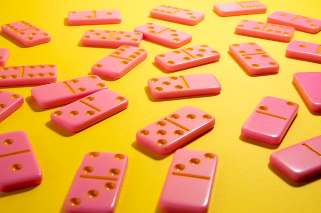 Pink board game domino on a yellow background