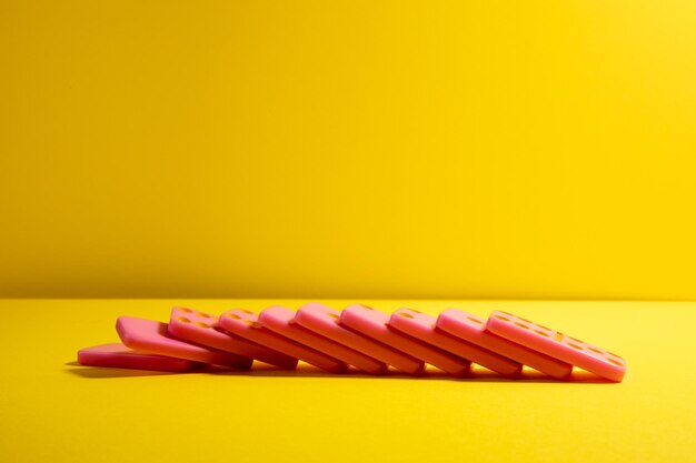 Pink board game domino on a yellow background