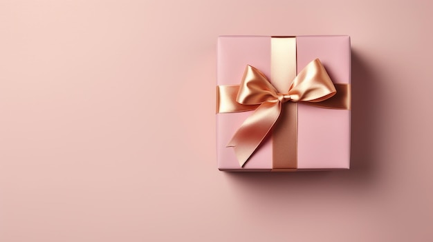 A pink box with a gold ribbon on it.