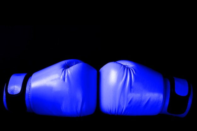 Pink Boxing glove in punching in black background in woman concept