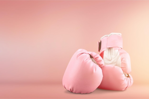 Pink boxing gloves on background