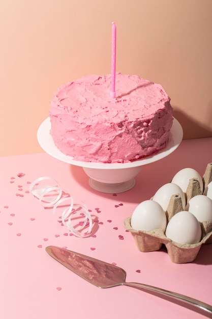 pink cake and candle arrangement high angle