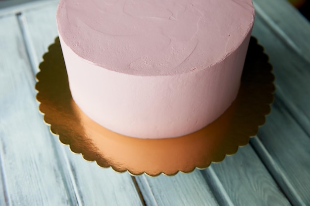 Pink cake is the perfect shape covered with cream On the stand Not decorated after freezing