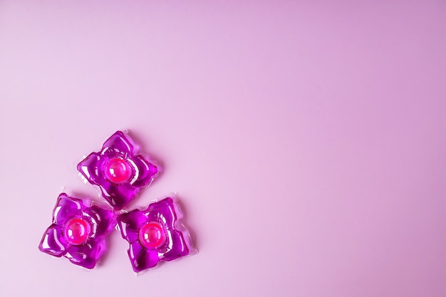 Pink capsules for washing clothes copyspace