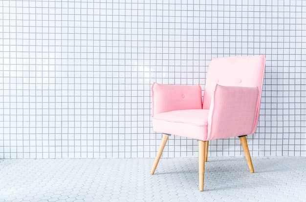 Pink chair on mosaic wall