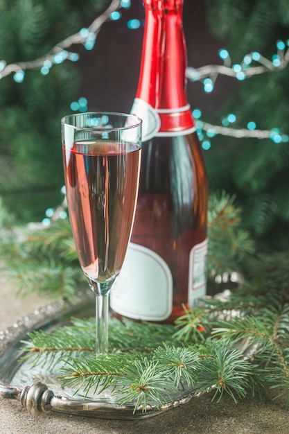 Pink champagne in a glass and christmas decorations