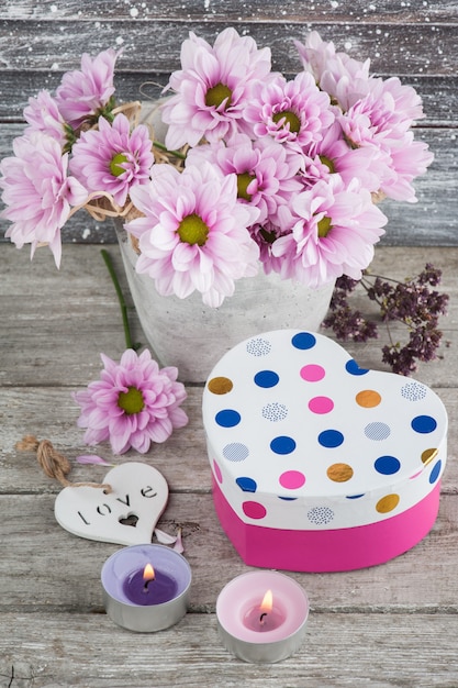 Pink chrysanthemum in concrete pot with gift