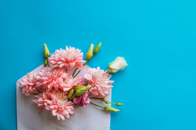 Pink chrysanthemum flowers and ranunculus flowers, gift or present, envelope