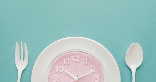 Pink clock on white plate