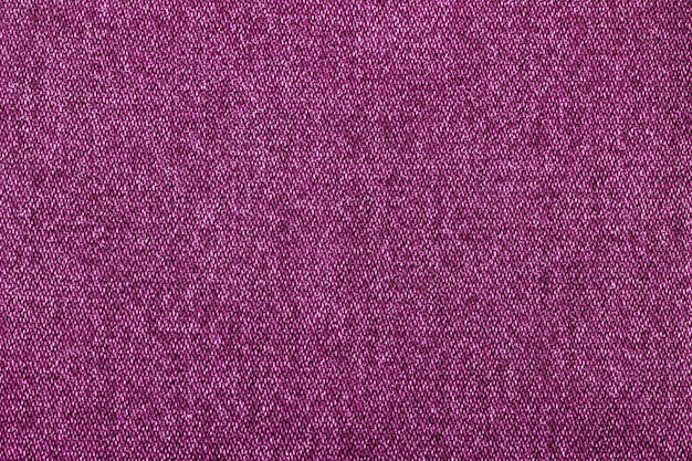 Pink color jeans texture factory fabric on white background close up