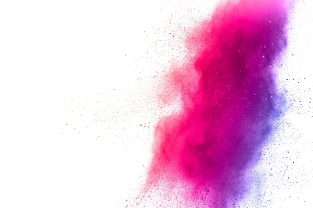 Photo pink color powder explosion on white background.