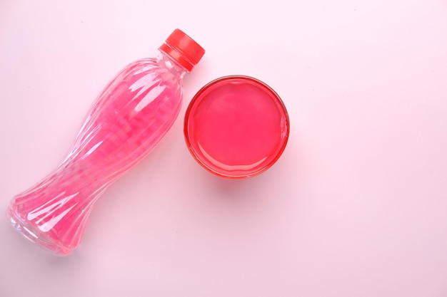 Pink color soft drink bottle on table