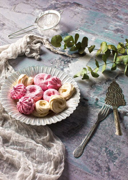 The pink cookies on wooden table background