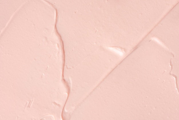 Sfondo di sbavature di argilla cosmetica rosa texture cosmetica cremosa rosa