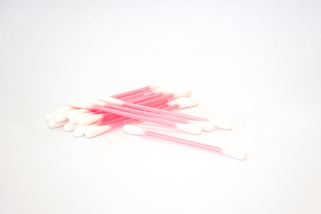 Pink cotton buds on a white background Cotton buds