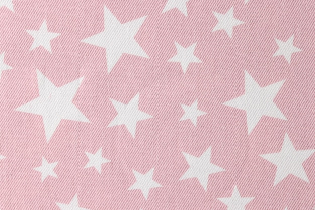 Pink cotton fabric with star pattern for children clothes upper view gentle textile material