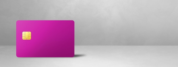 Pink credit card on a white concrete background