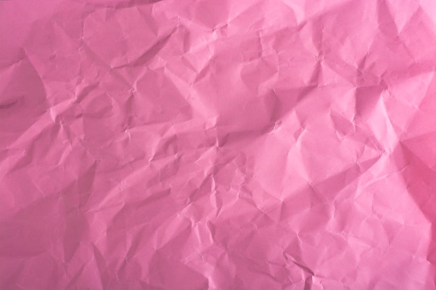 Pink crumpled paper close-up.