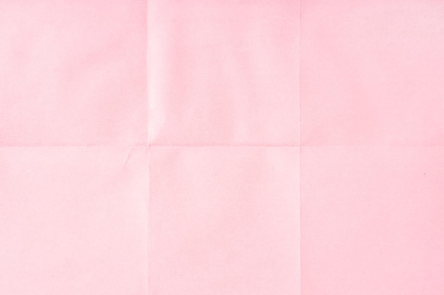 Pink crumpled unfolded paper sheet texture background Paper folded in six Full frame