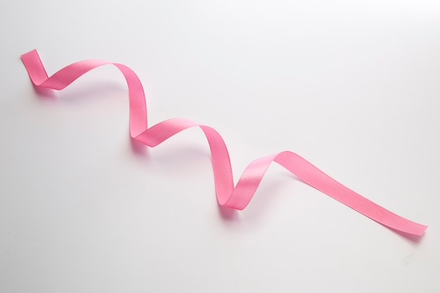 Pink curly ribbon isolated on white