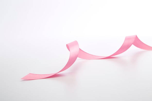 Pink curly ribbon isolated on white