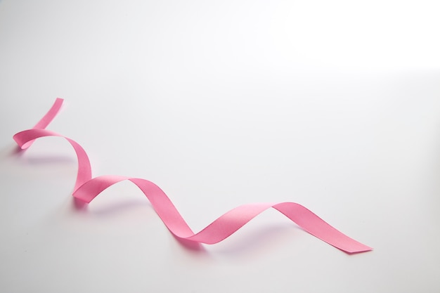 Pink curly ribbon isolated on white