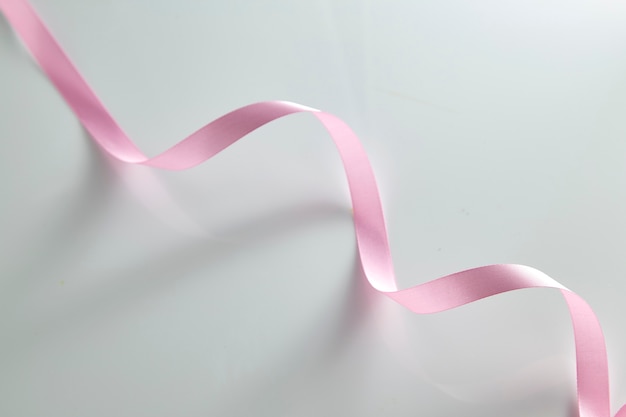 Photo pink curly ribbon on white