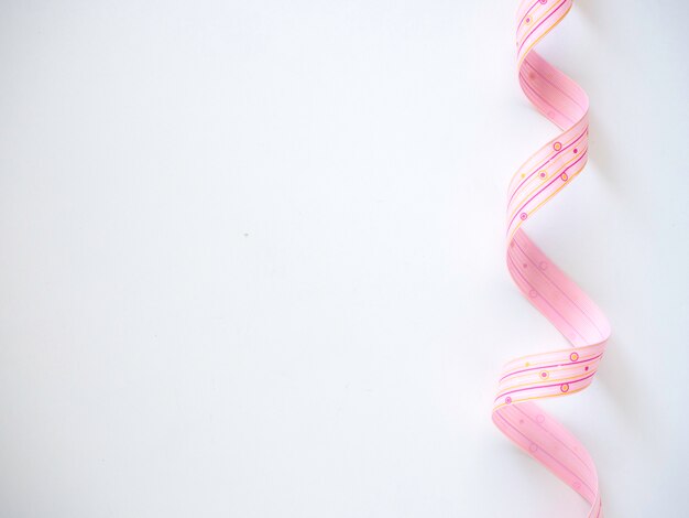 Photo pink curly ribbon on a  white