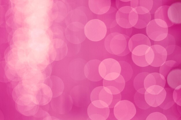 抽象的なボケライトのピンクの不焦点の壁紙の背景