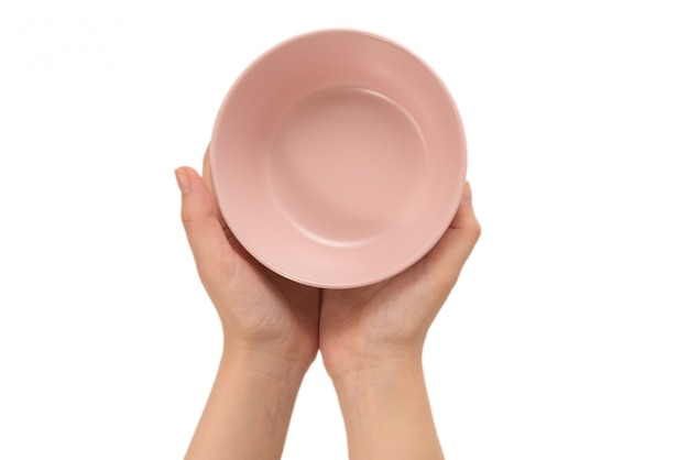 Pink dish in woman's hands isolated