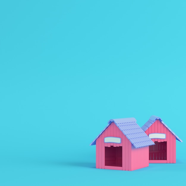 明るい青色の背景にピンクの犬小屋