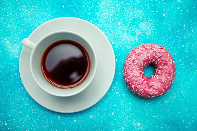 Pink donut and a cup of coffee