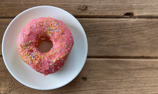 pink donut on a plate 