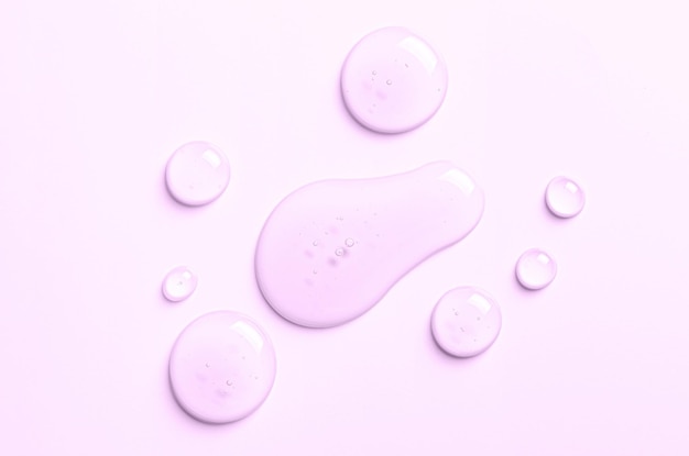 Photo pink drops of moisturizing gel or serum cosmetic product for skin care