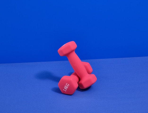 Pink dumbbells for the gym Body shaping and weight loss