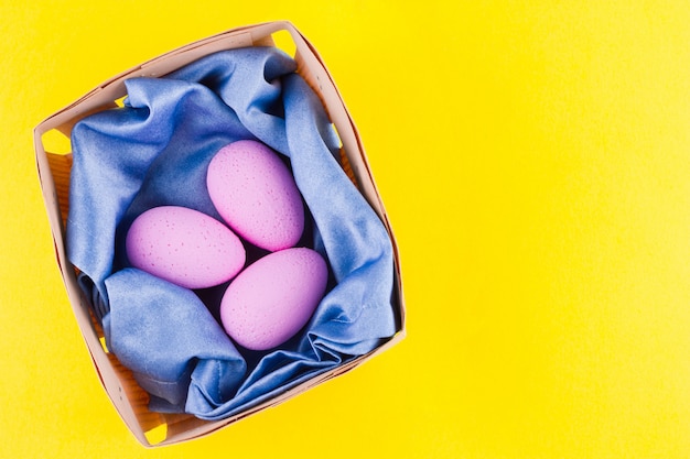 Pink Easter eggs in a wooden box. Easter minimal concept. Eggs in a basket