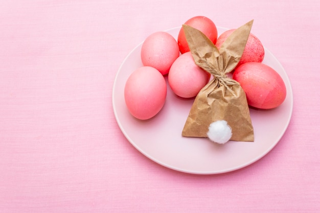 Pink eggs with bunny paper bag for Easter holiday